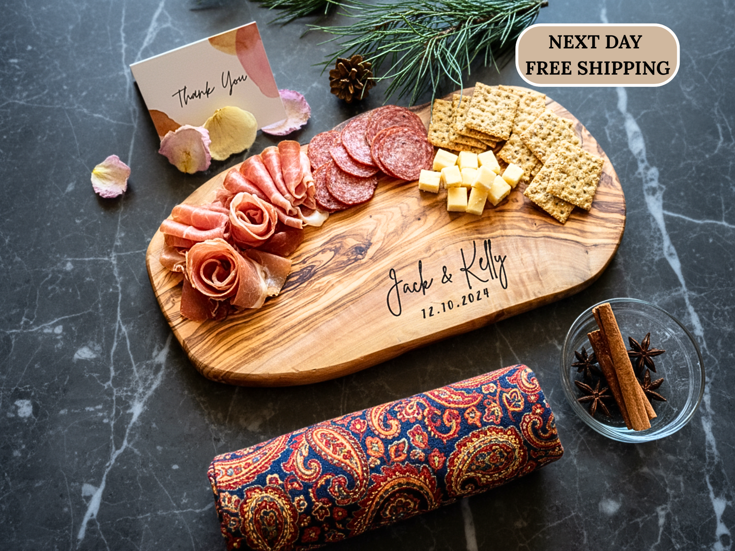 Wooden charcuterie board with meats, cheeses, and crackers on a dark surface